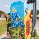 bluebonnet and sunflower art on traffic control box